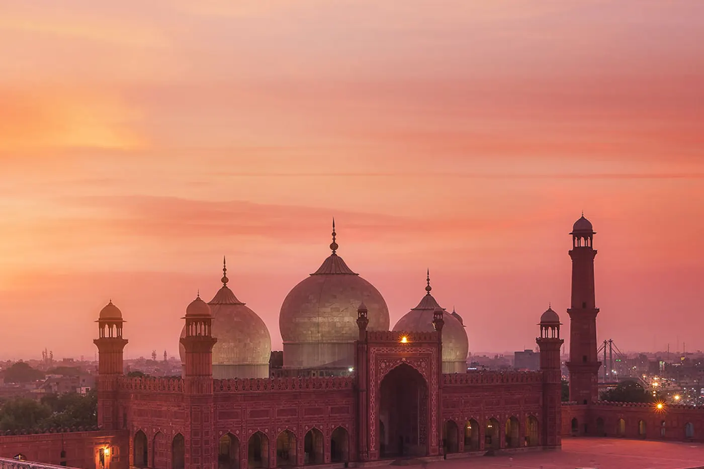 The Badshahi Mosque at sunset above the Lahore skyline